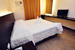 Postel nebo postele na pokoji v ubytování Citystate Asturias Hotel Palawan