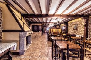 a restaurant with wooden tables and chairs in a room at La Antigua Botica in Pasarón