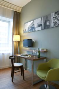 a room with a desk with a tv and a chair at Citadines Holborn - Covent Garden London in London