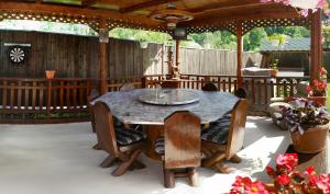 an outdoor table and chairs on a patio at Pensiunea Stefanescu in Voineasa