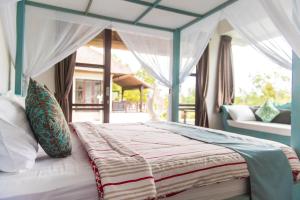 een slaapkamer met een hemelbed bij Villa Michiko in Uluwatu +31 foto's