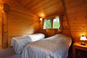 מיטה או מיטות בחדר ב-Rental Log Urube Village