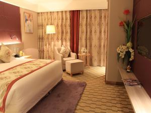 een hotelkamer met een bed en een stoel bij Hui Fu Jinling Hotel in Gaoyou