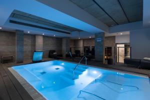 a large swimming pool in a hotel room at Catalonia Ramblas 4* Sup in Barcelona