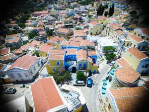 an aerial view of a town with colorful houses at Horio Village Rooms in Symi