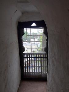 a large window in a building with a balcony at Labboo'z Café and Lodge in Maheshwar
