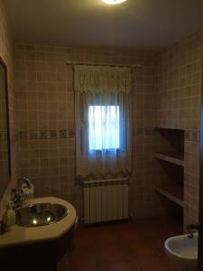 a bathroom with a sink and a window at La Chaparra in Carrascosa