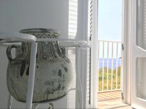 a large vase sitting on a table next to a window at Dimore Santojanni - La Casa sul Porto in Maratea