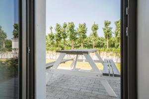 a picnic table sitting outside of a door at Holiday Suites Westende - Middelkerke in Middelkerke