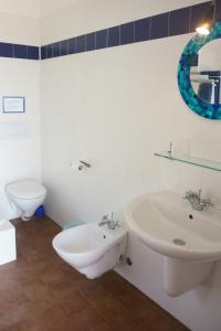 a white bathroom with a sink and a toilet at Farmhouse B&B Castagnola 64 in Ne