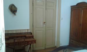 a room with a white door and a wooden cabinet at Patio das Flores in Ferreira do Alentejo