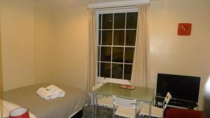 a small room with a table and a window at Regents Street Studios in Leamington Spa