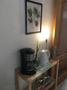 a table with a coffee maker on top of it at Pension Rosalia de Castro in Foz