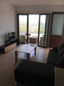 a living room with a couch and a coffee table at Kyperounta Apartment in Kyperounda