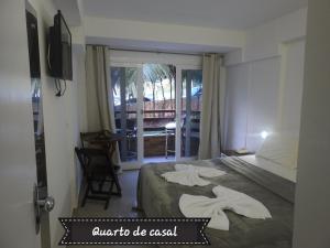 a hotel room with a bed with towels on it at Sonia Flats 214 - Flat privado no Apart Hotel Pipa's Bay in Pipa