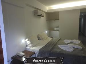 a bedroom with a bed with two towels on it at Sonia Flats 214 - Flat privado no Apart Hotel Pipa's Bay in Pipa +82 photos
