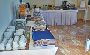 a buffet line with plates and dishes on a table at Element Hotel in Elafonisos