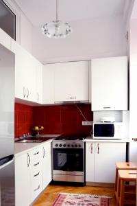 a kitchen with white cabinets and a stove top oven at Casa Blanca in Sibiu