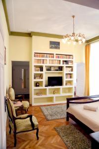 a living room with a large white book shelf at Casa Blanca in Sibiu