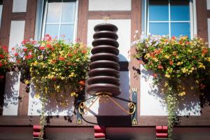 uma escultura com duas janelas e flores num edifício em Ferienapartments Schnibbe em Bad Lauterberg