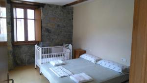 a bedroom with a white bed and a window at Ubilla Aterpetxea in Aulestia