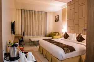 Postel nebo postele na pokoji v ubytování Hotel Grand Rio