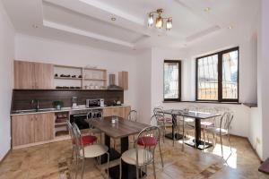 a kitchen with a table and chairs in a room at Dostyk Hostel in Almaty
