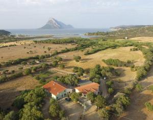 an aerial view of a house with a mountain in the background at B&B La Taerra in Porto San Paolo