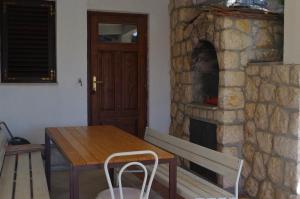 a dining room with a table and a stone fireplace at Apartment Lukovo - Puskaric in Lukovo +42 photos