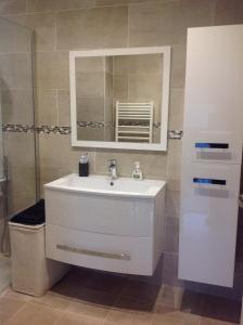 a bathroom with a white sink and a mirror at La Lanterne Plage in Nice