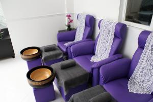 a group of purple chairs in a room at Loughborough Grange Guesthouse & Spa in Loughborough