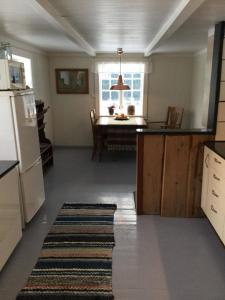 a kitchen with a refrigerator and a table in it at Staurset gård in Mittet