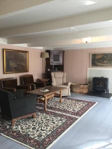 a living room with a table and chairs and a fireplace at Staurset gård in Mittet