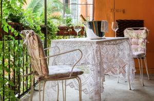 a table with two chairs and a vase on it at Casa Borsari Suite in Verona