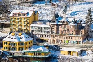 a group of buildings with snow on them at Residenz Lothringen by AlpenTravel in Bad Gastein