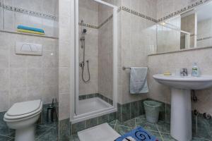 a bathroom with a shower and a toilet and a sink at Guesthouse Casa Nova in Poreč