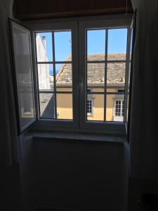 an open window with a view of a building at Pension Rosalia de Castro in Foz