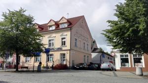 a large building with a roof on a street at Domus in Ustka