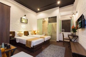 Ένα ή περισσότερα κρεβάτια σε δωμάτιο στο Luxury Backpakers Hotel