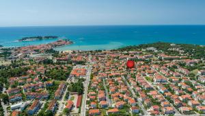 a red balloon flying over a city next to the ocean at Guesthouse Casa Nova in Poreč