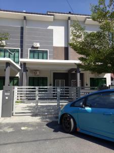 a blue car parked in front of a house at Amanda Homestay Dungun 1 in Dungun