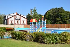 a playground with a water slide in a park at Hotel Rokiten in Moravský Krumlov