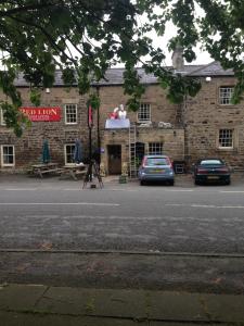 a building with a car parked in front of it at Red Lion Inn in Newbrough