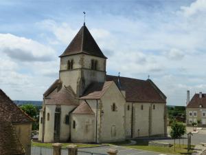 une vieille église avec une tour dans une rue dans l'établissement Chez Casimir, à Cercy-la-Tour
