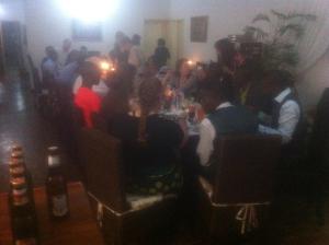 a group of people sitting at a table in a room at Kuku Royal Lodge in Ndola