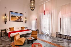 
a living room filled with furniture and a large window at Hotel & Spa Dar Bensouda in Fez
