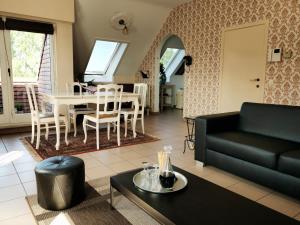 a living room with a couch and a table at Hotel Apartments Belgium - HAB 2 in Westerlo