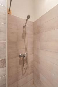 a shower with a shower head in a bathroom at 27 Shades of Green (4 bedroom 3 Bath Sunny Central) in Budapest