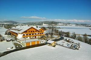 an aerial view of a building in the snow at Landhotel Wiesbauer in Füssen