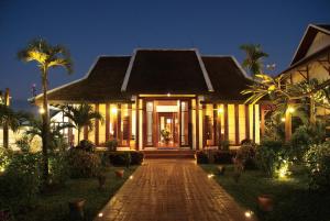a house with a pathway leading to it at night at Green Park Boutique Hotel in Vientiane